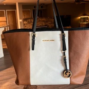 Large black white and tan Michael kors purse.